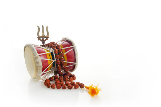 Shivaratri background with Shivas trident and Pellet Drum Damroo musical instrument . Hindu festival Maha Shivratri