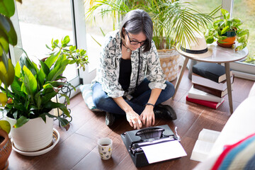 Top view of adult woman typing on typewriter. Work from home concept.