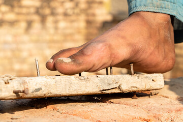 laborer accidentally foot on nail