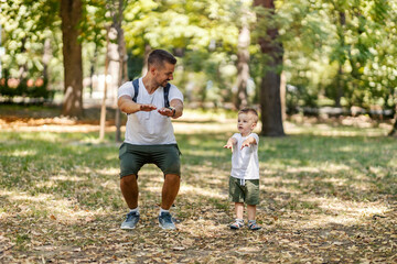 Fototapeta premium Father teaching son exercises in nature.