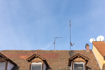 house roofs with blue sky and tv antennas