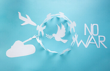 There is no war. People cut out of paper on a blue background protect the dove of peace.The concept of the World Peace Day