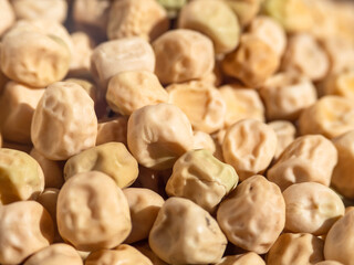 Unfocused pea seeds close-up-abstract natural background. Macrophotography of light yellow peas with a shallow depth of field in the center. A pile of dried peas for a food background