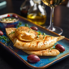 Grilled squid. calamari on plate with lavash, tzatziki sauce