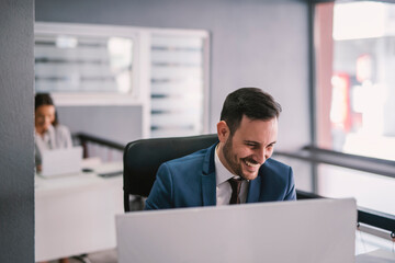 A businesswoman working on computer in modern office.