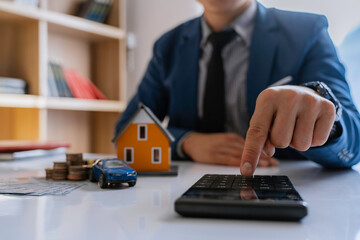 Real estate agents are analyzing and making home loan decisions for clients to sign real estate sales contracts. A bank employee recommends approval for a mortgage loan.
