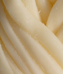 Pigtail of cheese as an abstract background.