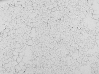 Cracked white paint on the wall as an abstract background.