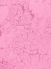 Cracked pink paint on the wall as an abstract background.