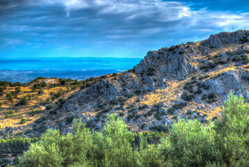 Fototapeta premium Grassy mountain with rolling clouds and blue sky. Monochrome. Black and white