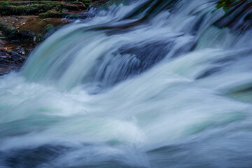 Fototapeta na wymiar View of a small waterfall on the East Lyn River