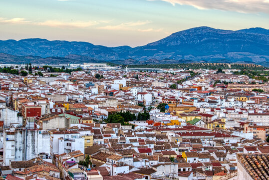 Traditional Spanish whitewashed village with mountain and ruined castle on the sumit. Monochrome black and white