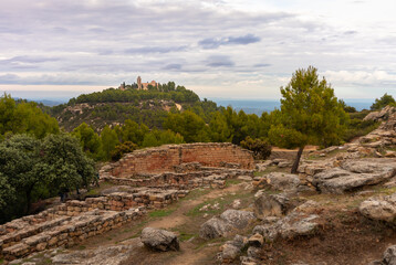 Ermitage San Cristobal and ancient ruins of an Iberian settlement on a hill close to Calaceite,...