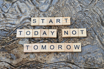 start today not tomorrow  text on wooden , motivation and business quotes