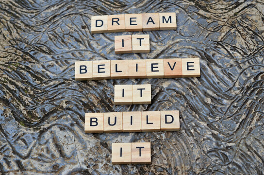dream it beleave it built it text on wooden square, business and motivation quotes