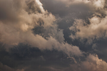 stormy clouds lit by a dim light, blown by strong winds.