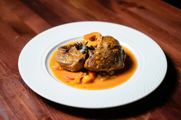 Meat baked with vegetables and yellow sauce.