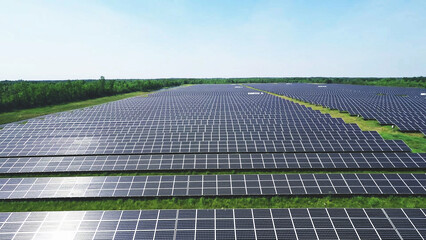 beautiful aerial view of solar panels on solar farm during a sunny day with plants and sky in the background. - 489538758