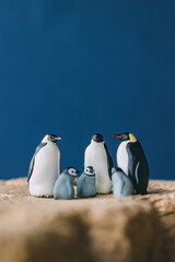 Obraz premium Cute miniature toy penguin colony. Wild animal family.