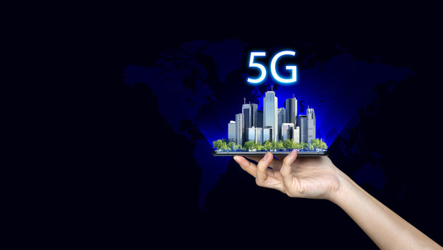 5G internet connection digital tablet concept. Businessman hold mobile with 5G broadband cellular network around city.