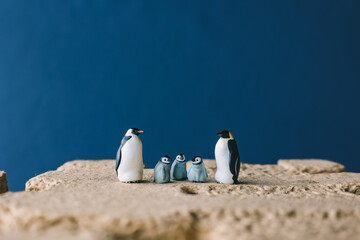 Fototapeta premium Cute miniature toy penguin colony. Wild animal family.