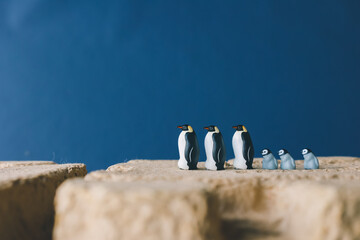 Cute miniature toy penguin colony. Wild animal family. © Yoshi