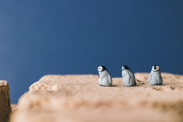 Cute miniature toy penguin colony. Wild animal family. © Yoshi