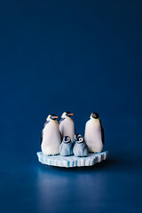Cute miniature toy penguin colony. Wild animal family. © Yoshi