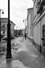 Black and white photography. View of the street with old two-story houses. February 11, 2022, Moscow, Russia.