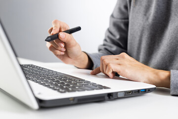 Designer sitting at desk and working at laptop