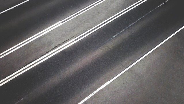 empty asphalt road with lines or stripes from top aerial drone high view background.
