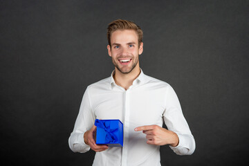 happy businessman pointing finger on business reward for occasion greeting