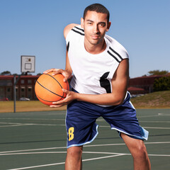 Ive got skills. A young basketball player prepares to dribble a ball.