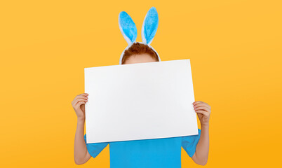 A child in an Easter bunny costume holds an empty piece of paper