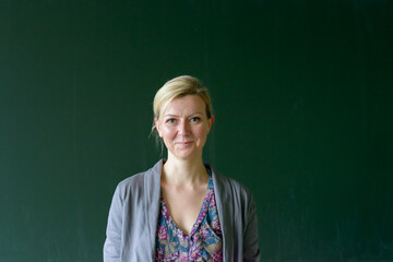 Attractive blond teacher smiling at the camera