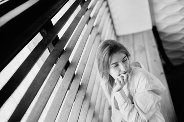 Thoughtful young girl looking away near the window