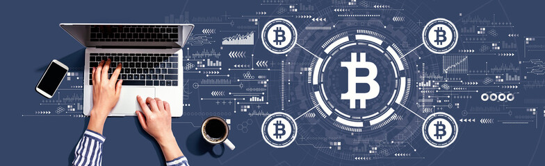 Obraz na płótnie Canvas Bitcoin theme with person using a laptop computer