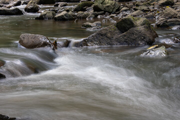 Naklejka na ściany i meble water flowing into the river