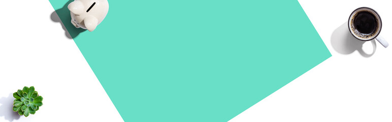 Piggy bank and a cup of coffee - flat lay