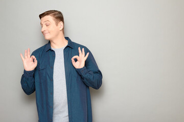 Portrait of happy mature man showing okay gestures and smiling