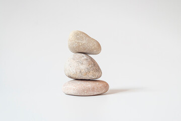 Obraz na płótnie Canvas Isolated on white background. Stack of white natural stone.your mind, your soul balancing, begging, meditation concept.