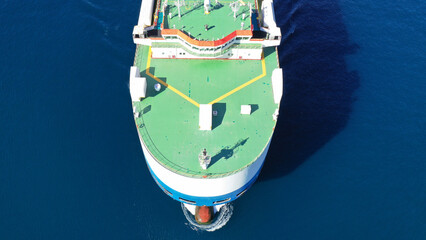 Aerial drone photo of huge car carrier ship RO-RO (Roll on Roll off) cruising in Mediterranean deep blue Aegean sea