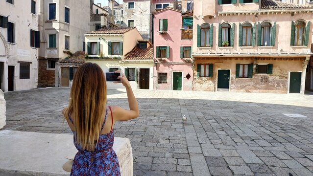 
taking photos on a mobile phone in a romantic place Italy Venice