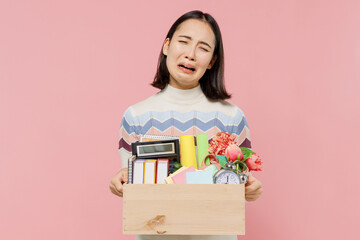 Disappointed sad teen student girl of Asian ethnicity in sweater backpack hold books hold box of...