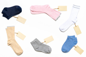 Various modern trendy women's cotton socks set with price tags on white background. Fashionable socks store. Socks shopping, sale, merchandise, advertisement concept. Flat lay, top view, copy space