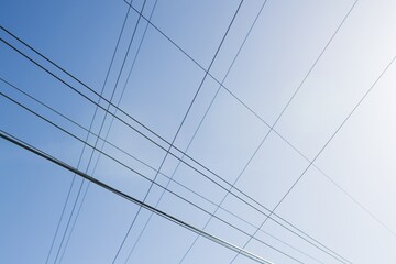 High voltage columns, in the background with blue sky and clouds. Prices of electricity, consumption, ecology.