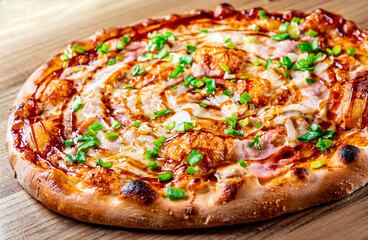 Pizza with chicken and barbeque sauce. Italian pizza on wooden table background