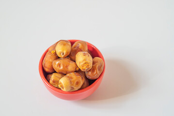 Plate of dates in red bowl on white background. top view.
Ramadan concept.