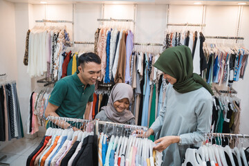 muslim family shopping together at the mall buying some new clothes