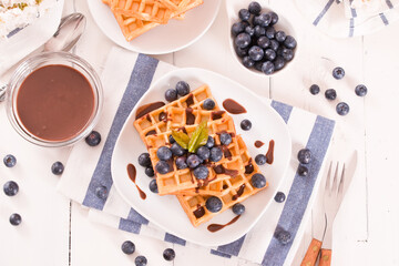 Waffles with blueberries and chocolate cream.